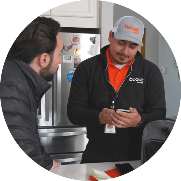 Boost Mobile technician consulting a homeowner