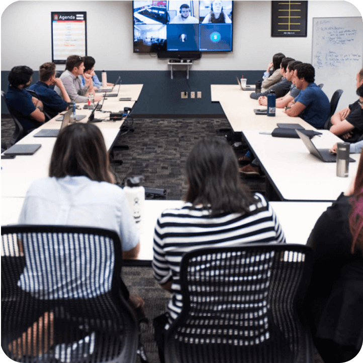 Many team members around a table in a conference room