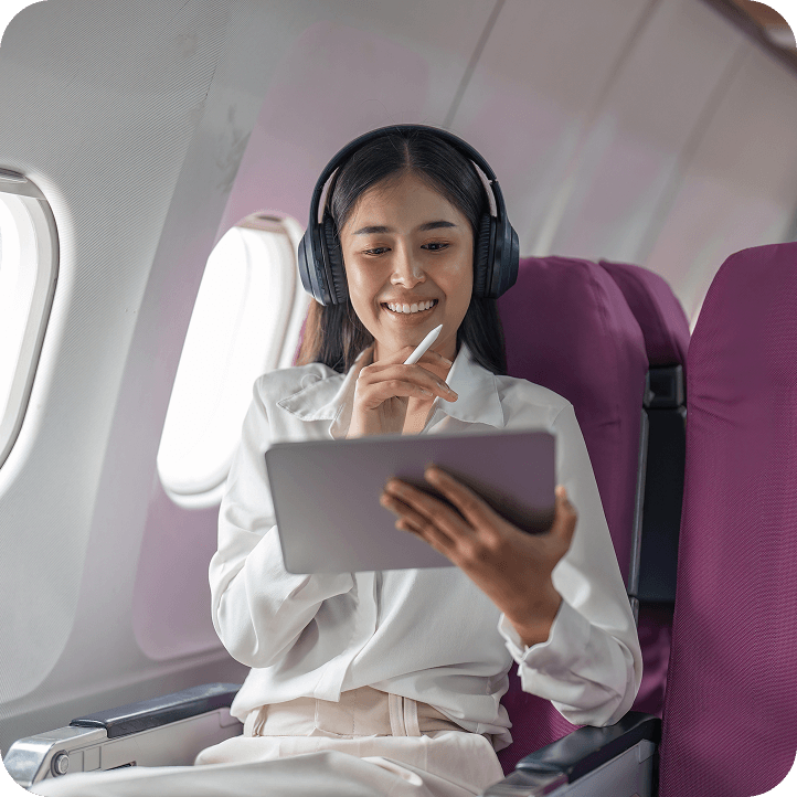 Woman enjoying tablet on a plane