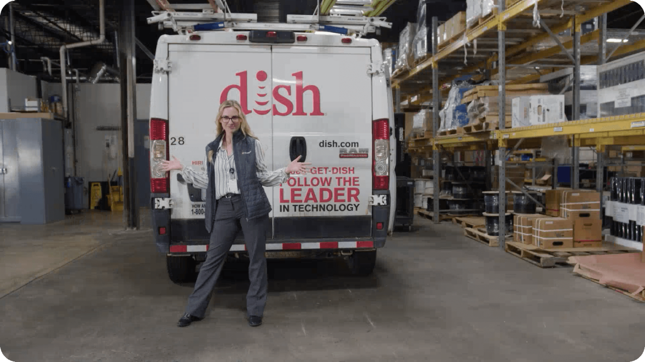Molly Cook standing in front of a DISH van