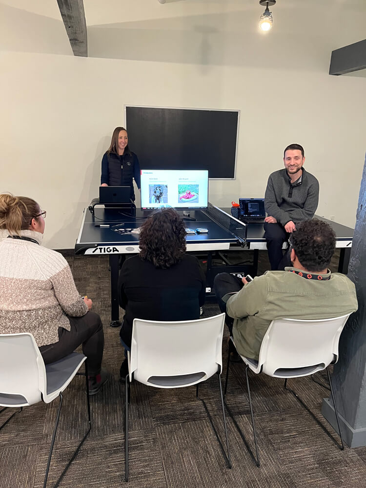 Group of individuals seated around a screen