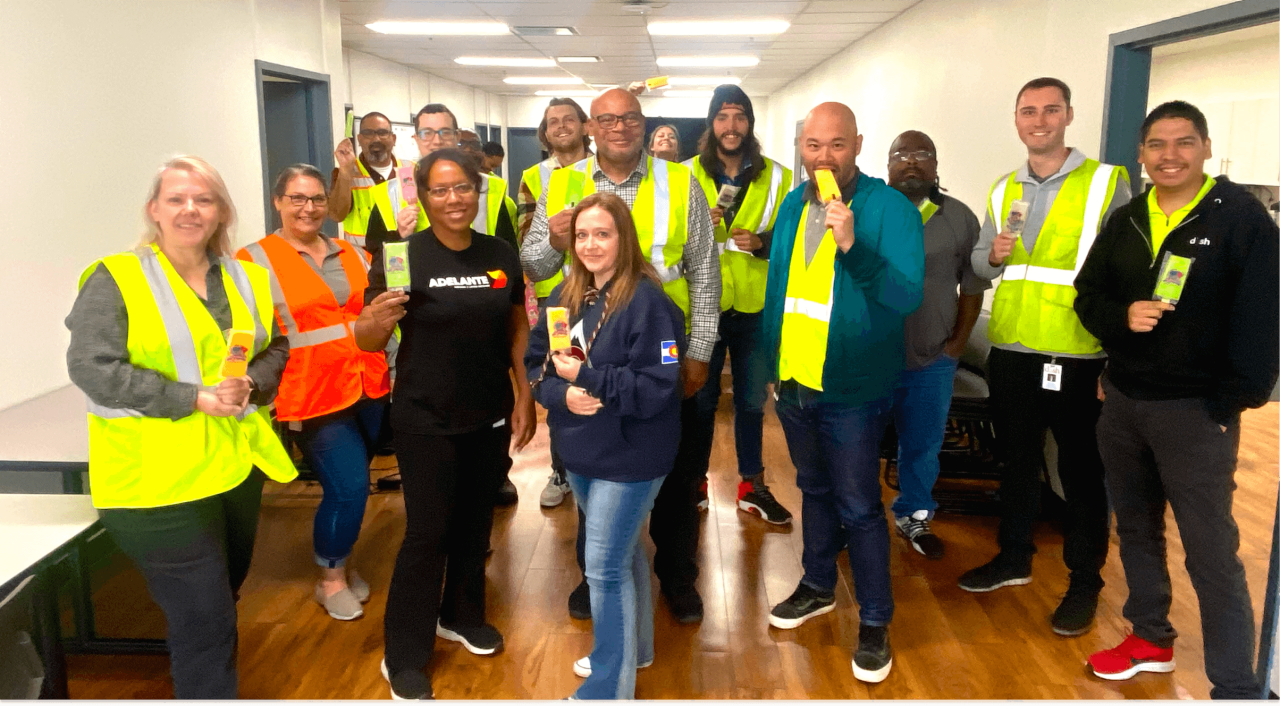 Group photo of a team in neon vests. 