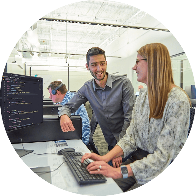 Team members working in front of a computer