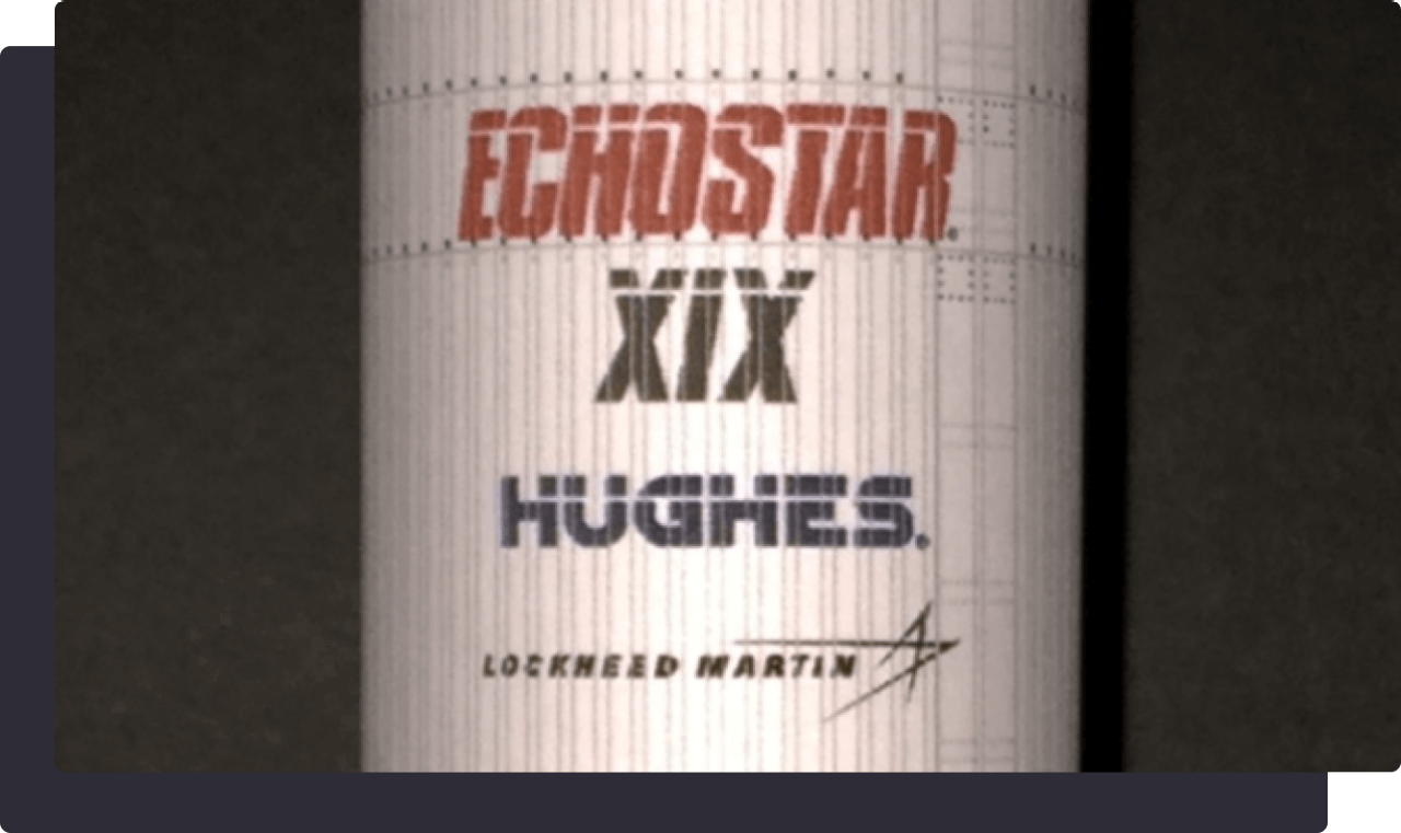 Close-up of a rocket labeled EchoStar XIX, Hughes, and Lockheed Martin.
